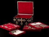a red box with silverware in it on a black background