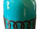 a blue vase that is sitting on a stand