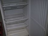 an empty refrigerator with its door open in a room