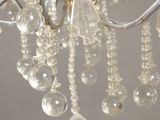 a close up of a chandelier with a bunch of beads hanging from it