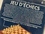 the box is open to show the contents of a game of chess