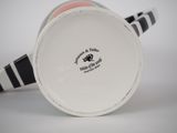 a close up of a coffee cup with a black and white stripe pattern