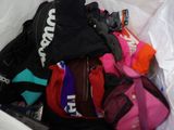 a white bag filled with different types of backpacks