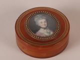 a small wooden box with a picture of a woman on it
