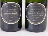 two bottles of wine sitting next to each other on a white surface