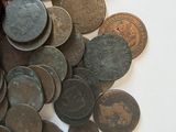 a pile of coins sitting on a white surface