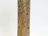 a tall vase with a design on it on a white surface