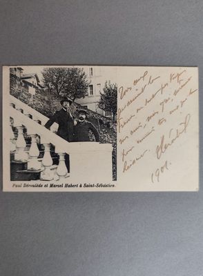 une vieille photo d'un homme assis sur un banc devant un immeuble