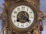 a close up of a gold clock with roman numerals on it