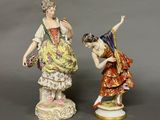 pair of porcelain figurines of a woman and a boy