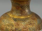 a vase that has a gold and blue design on it