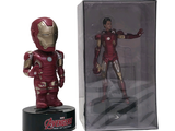 figurine of iron man in a box next to it ' s packaging