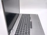 a silver laptop with a black keyboard on a white surface