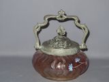 a small vase with a lid sitting on a table