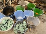 many buckets that are sitting on the ground next to each other