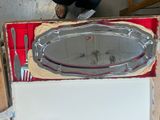 a box with a silver platter and a knife and fork in it