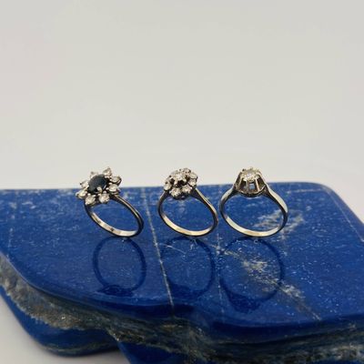 a couple of rings sitting on top of a blue stone