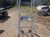 a ladder that is sitting on the ground in the dirt