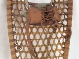 two snowshoes hanging on the wall next to each other