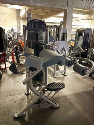 a gym room with machines and other equipment in it