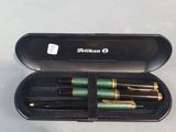 a green pen in a black case on a table