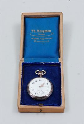 a silver pocket watch in a blue box on a white surface