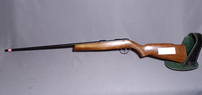 a rifle that is sitting on a table with a gun in it