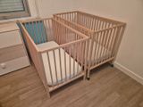 a crib with a mattress in the corner of the room