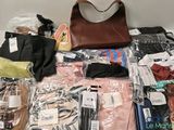 a lot of clothes and accessories laid out on the floor