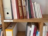 a bookshelf with many books on it in a room