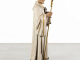a statue of a man in a robe holding a staff