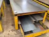 a group of steel plates stacked on top of each other in a warehouse