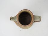 a close up of a cup on a white surface