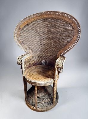 an old wicker chair with a wooden seat and foot rest