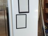 a white refrigerator that is sitting in the corner of a room