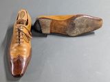 pair of men ' s shoes sitting on a table next to each other