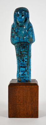 an image of a blue statue of a person on a wooden stand
