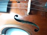 a close up of a violin that is on a table