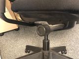 a black office chair that is sitting on the floor