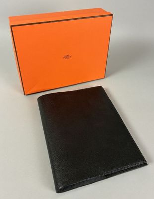 an orange and black wallet sitting next to an orange box
