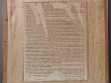 an old piece of paper with writing on it sitting on top of a table