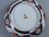 a close up of a plate with a flower design on it