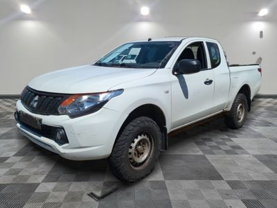 a picture of a white pick up truck parked in a garage
