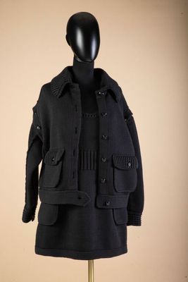 black wool coat on a mannequin stand