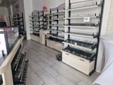 many shelves of cosmetics products in a store that is empty