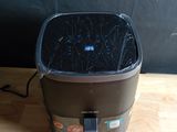 a black trash can sitting on a wooden table