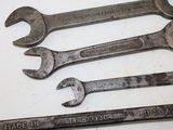 four wrenches that are sitting on a table