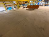an image of a large warehouse with a bench in the middle of the room