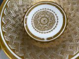 a gold and white plate with a gold design on it
