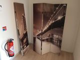 a room divider with a picture of a bridge and fire extinguisher